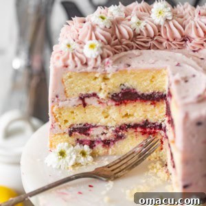 A perfectly sliced Lemon Blackberry Cake, highlighting its vibrant layers.