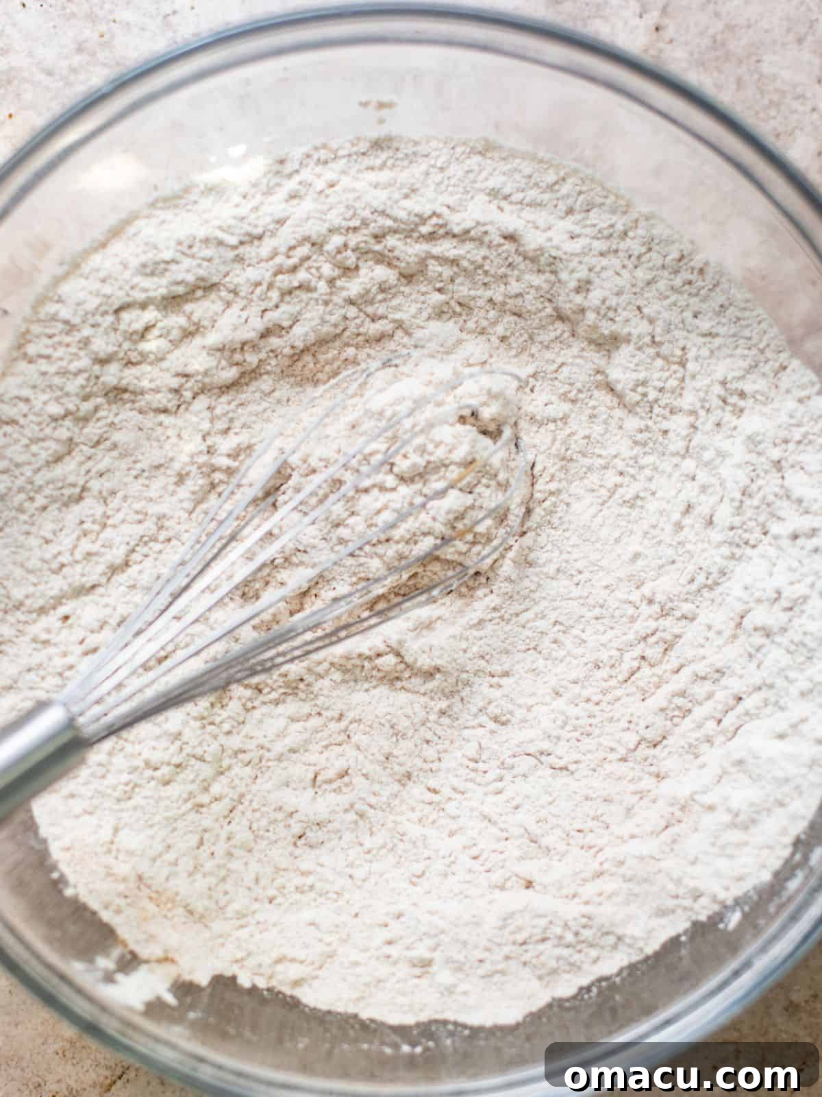 Dry ingredients for the lemon cake whisked together in a mixing bowl.
