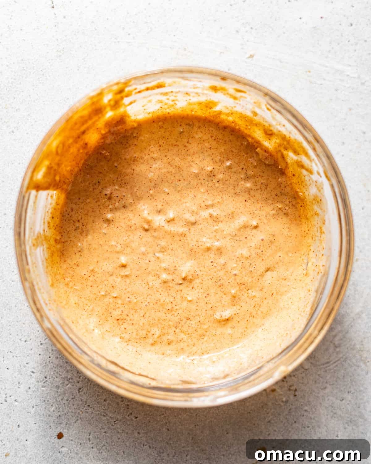 All Big Mac Special Sauce ingredients mixed together in a bowl, creating a creamy, orange-pink dressing.