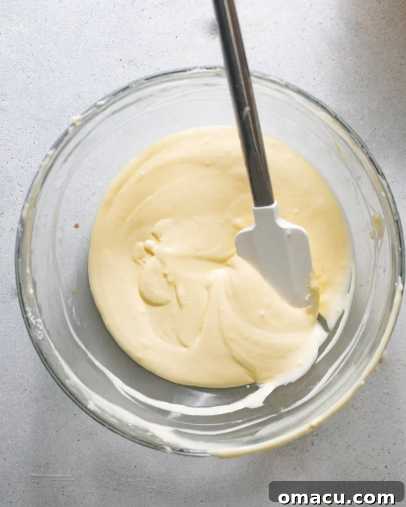 Smooth Basque cheesecake batter mixed together in a bowl, ready for baking.