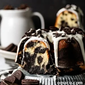 A slice of Oreo pound cake cut out, showcasing the beautiful marbled pattern within, sitting on a serving plate.