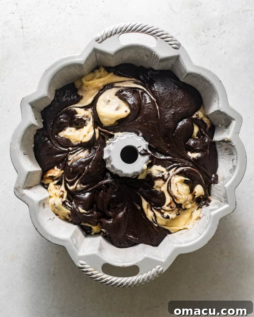 The marbled batters, light Oreo and dark cocoa, swirled together in a bundt pan before baking.