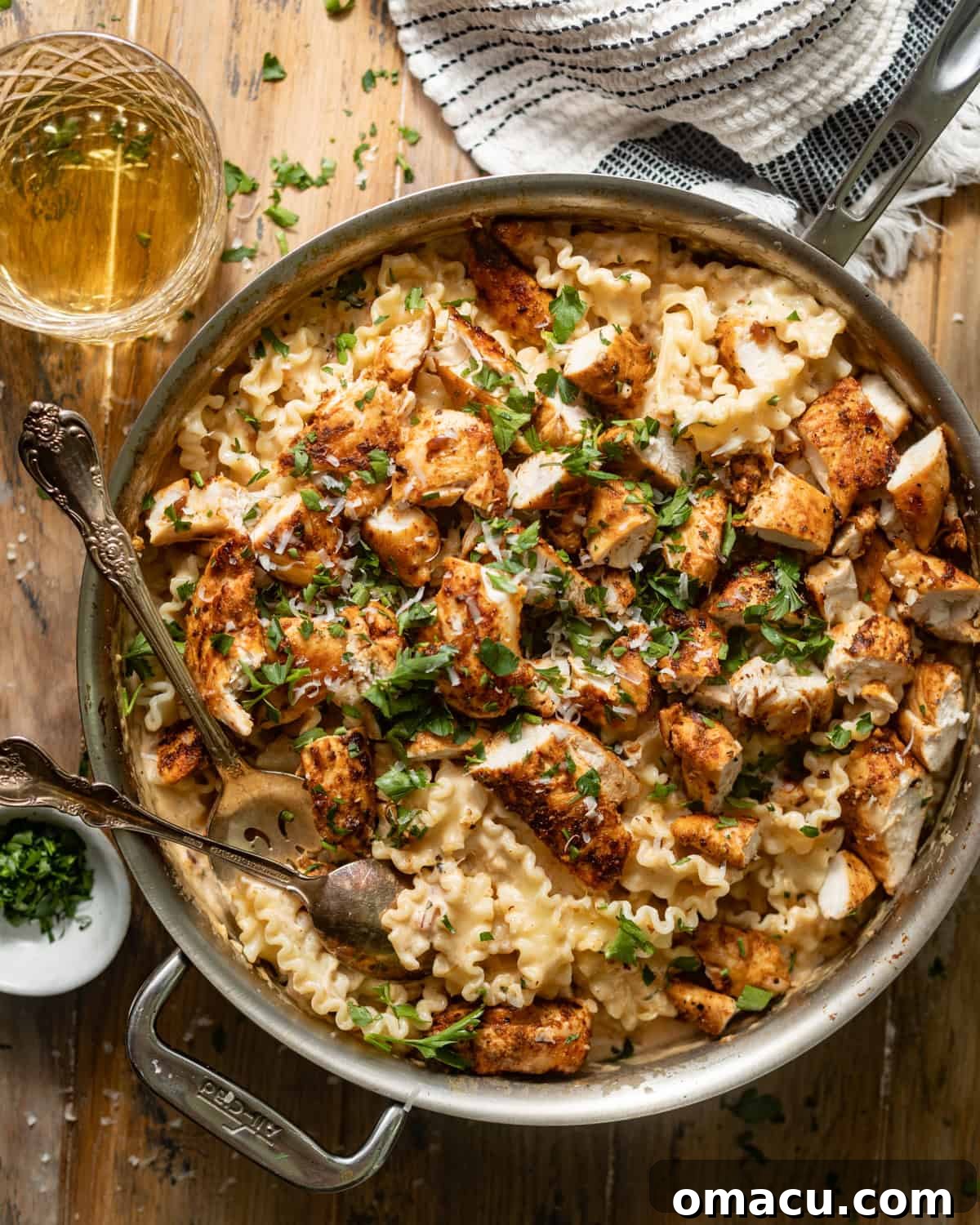 Garlic Parmesan Pasta with Chicken in a large skillet garnished with fresh parsley, ready to be served.