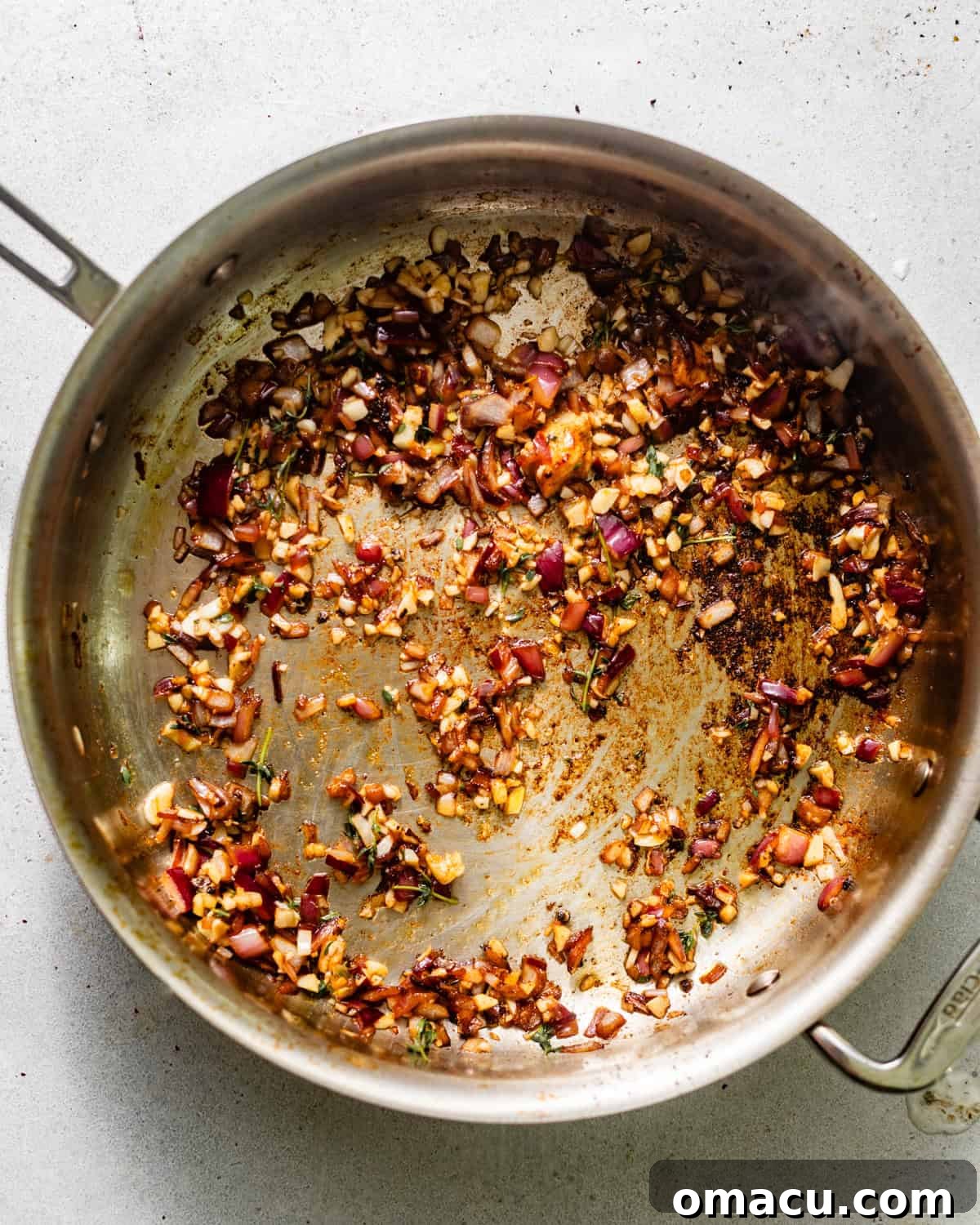 Finely diced shallots and minced garlic sizzling in olive oil and melted butter in a large skillet.