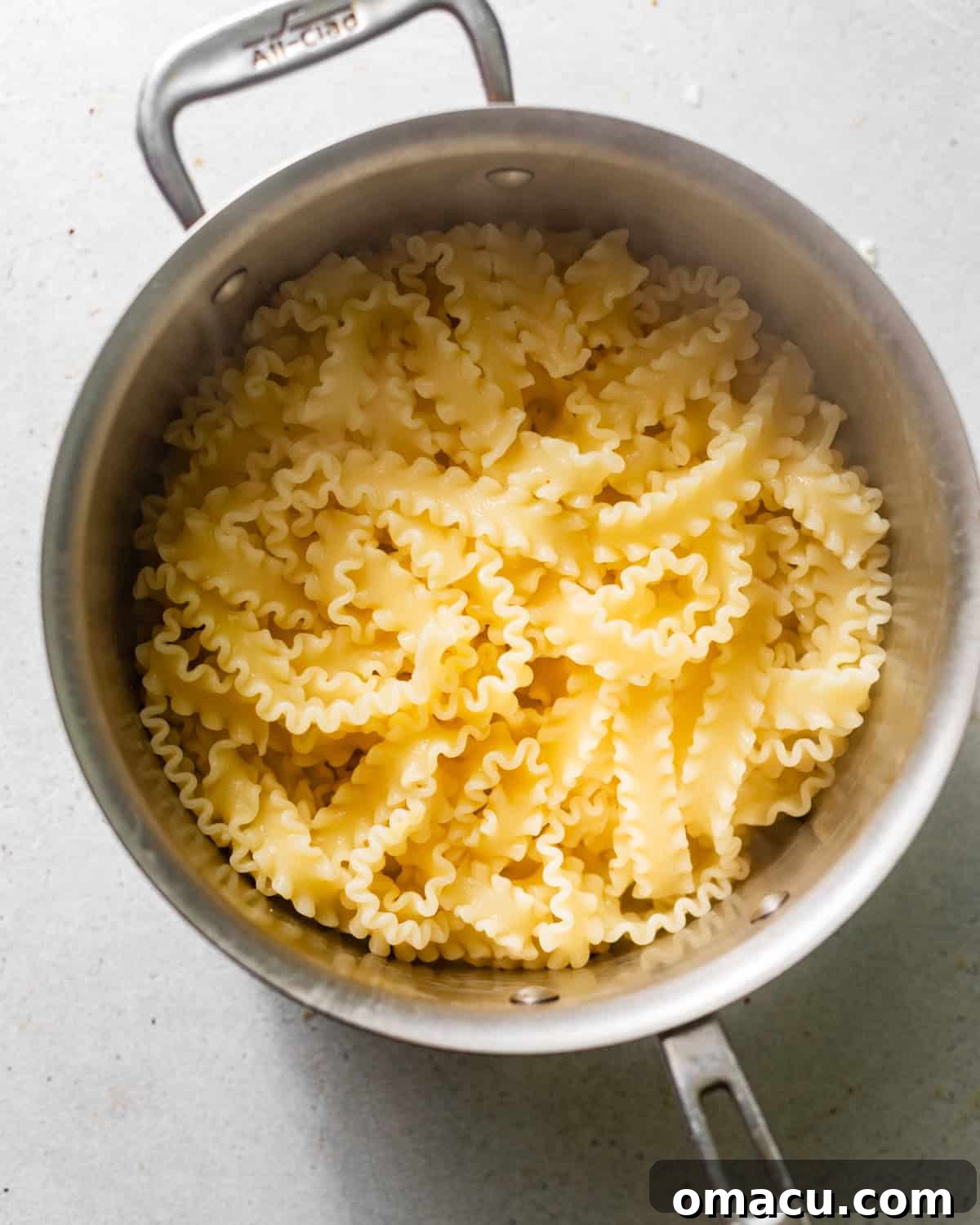 Fresh pasta boiling until al dente in a large pot of salted water.