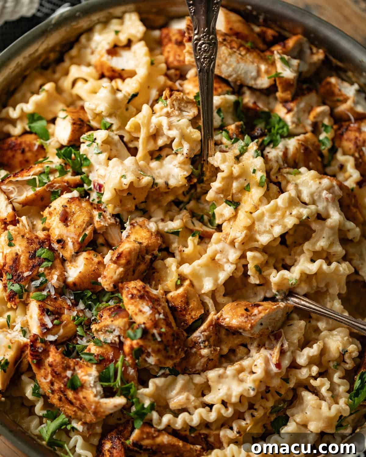 Garlic Parmesan pasta with chicken mixed in a large skillet, ready to be served.
