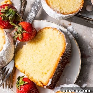 A slice of mascarpone pound cake on a plate with a fork.