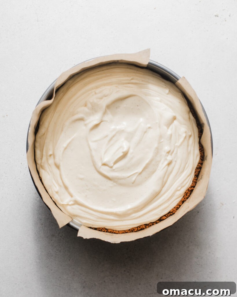 Mascarpone cheesecake batter poured into a springform pan with a prepared crust.