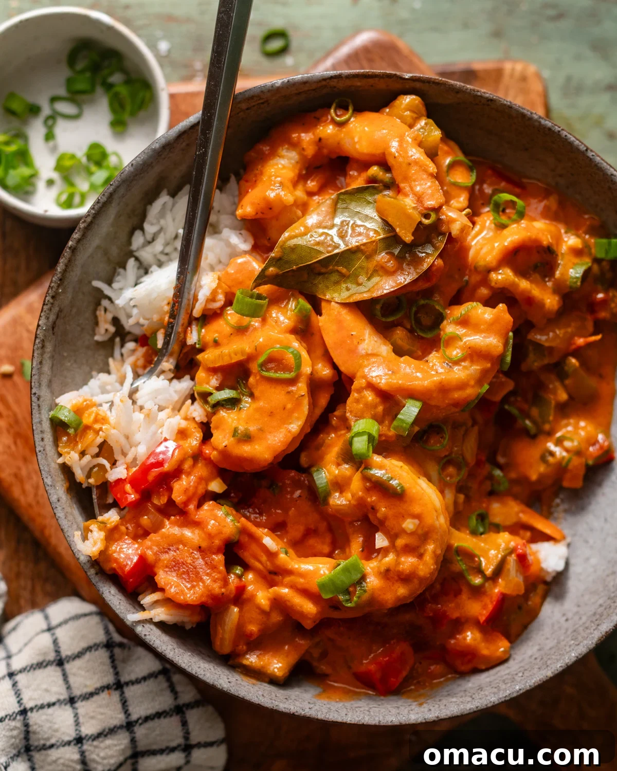 louisiana shrimp creole in a bowl with rice and a spoon.