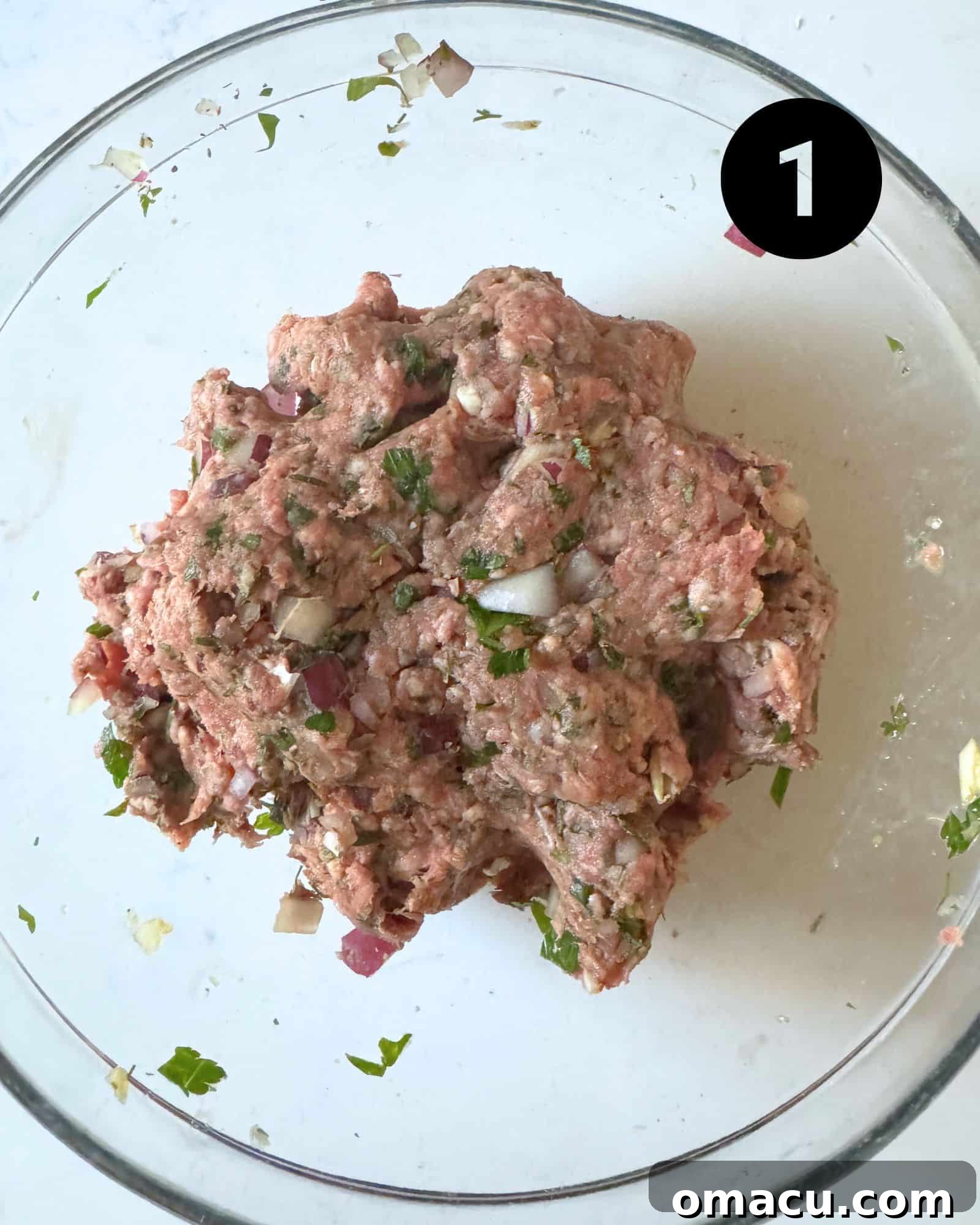 All meatball ingredients perfectly mixed together in a large mixing bowl, ready for forming.