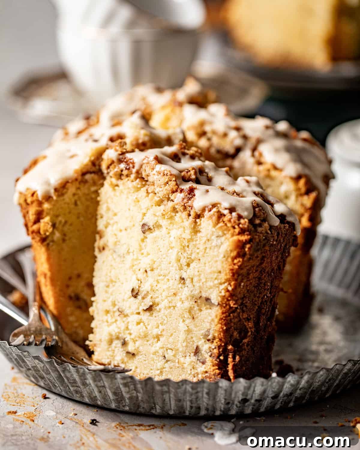 A slice of Louisiana crunch cake on a serving tray, showing its moist interior and crunchy topping.