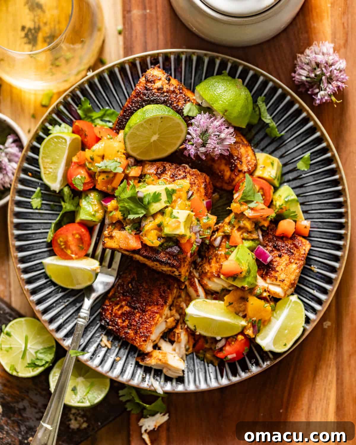 A beautifully pan-seared blackened Mahi Mahi fillet on a white plate, topped with a fresh, vibrant peach salsa. A fork rests beside the plate, ready to enjoy this healthy and delicious seafood meal.