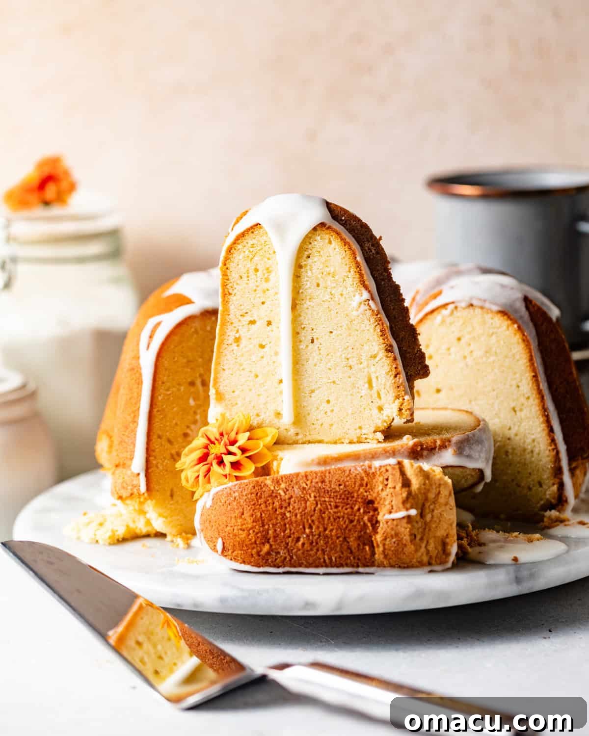 Stacks of perfectly sliced 7 flavor pound cake, showing off its golden crumb and inviting texture.