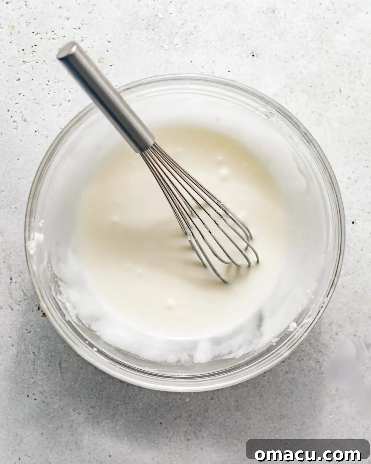 Half and half, sour cream, and all seven extracts (vanilla, butter vanilla, lemon, coconut, rum, orange, almond) gently whisked together in a separate bowl.