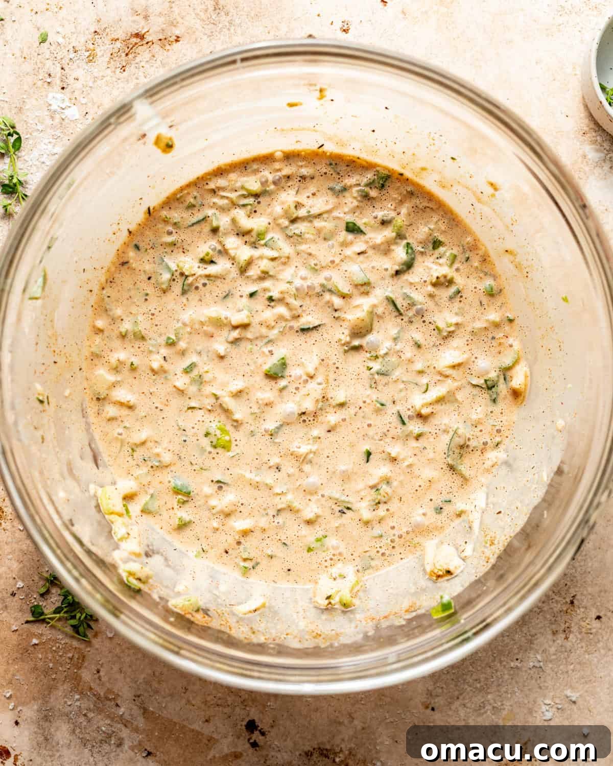 Creamy Cajun coleslaw dressing mixed in a large bowl, showcasing its smooth texture and vibrant color.