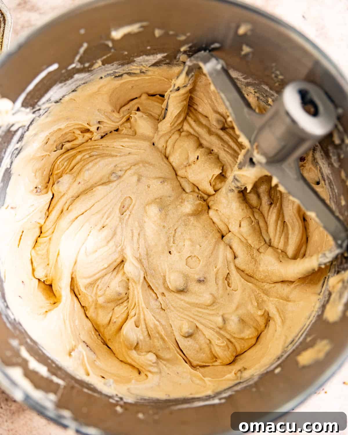 Prune cake batter, smooth and well-mixed, in a bowl.