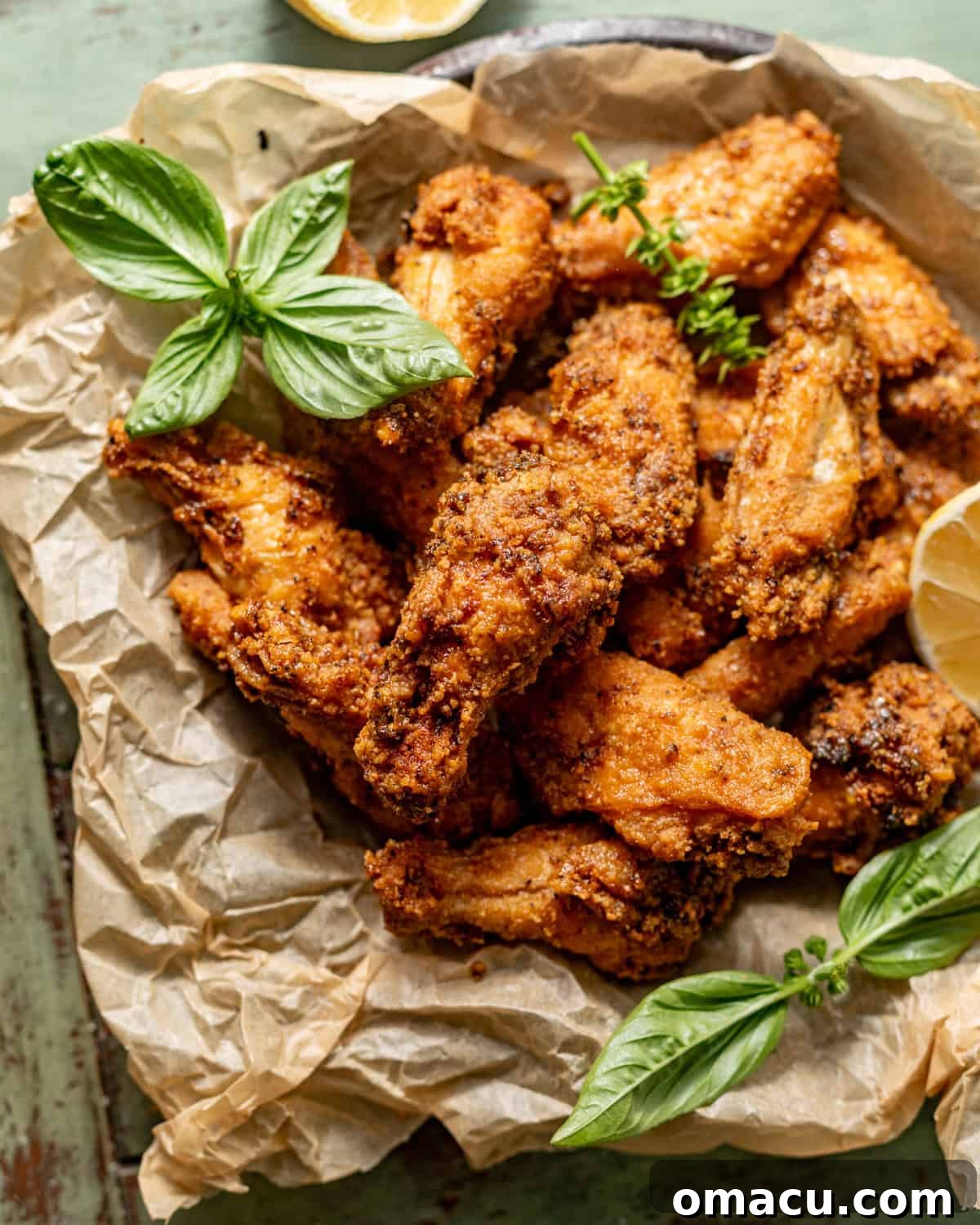 An inviting overhead view of a platter of perfectly golden-brown lemon pepper wings, ready to be enjoyed, showcasing their crisp texture and vibrant seasoning.