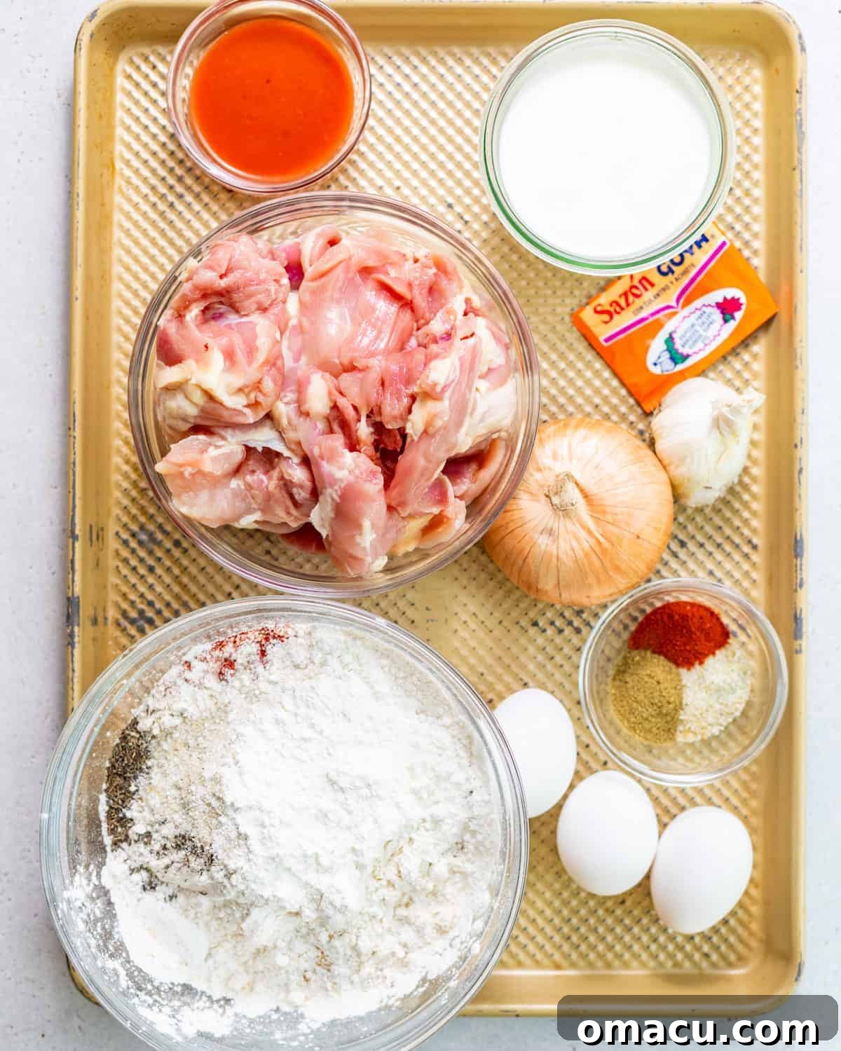 ingredients to make nashville hot chicken sandwiches on a baking sheet.