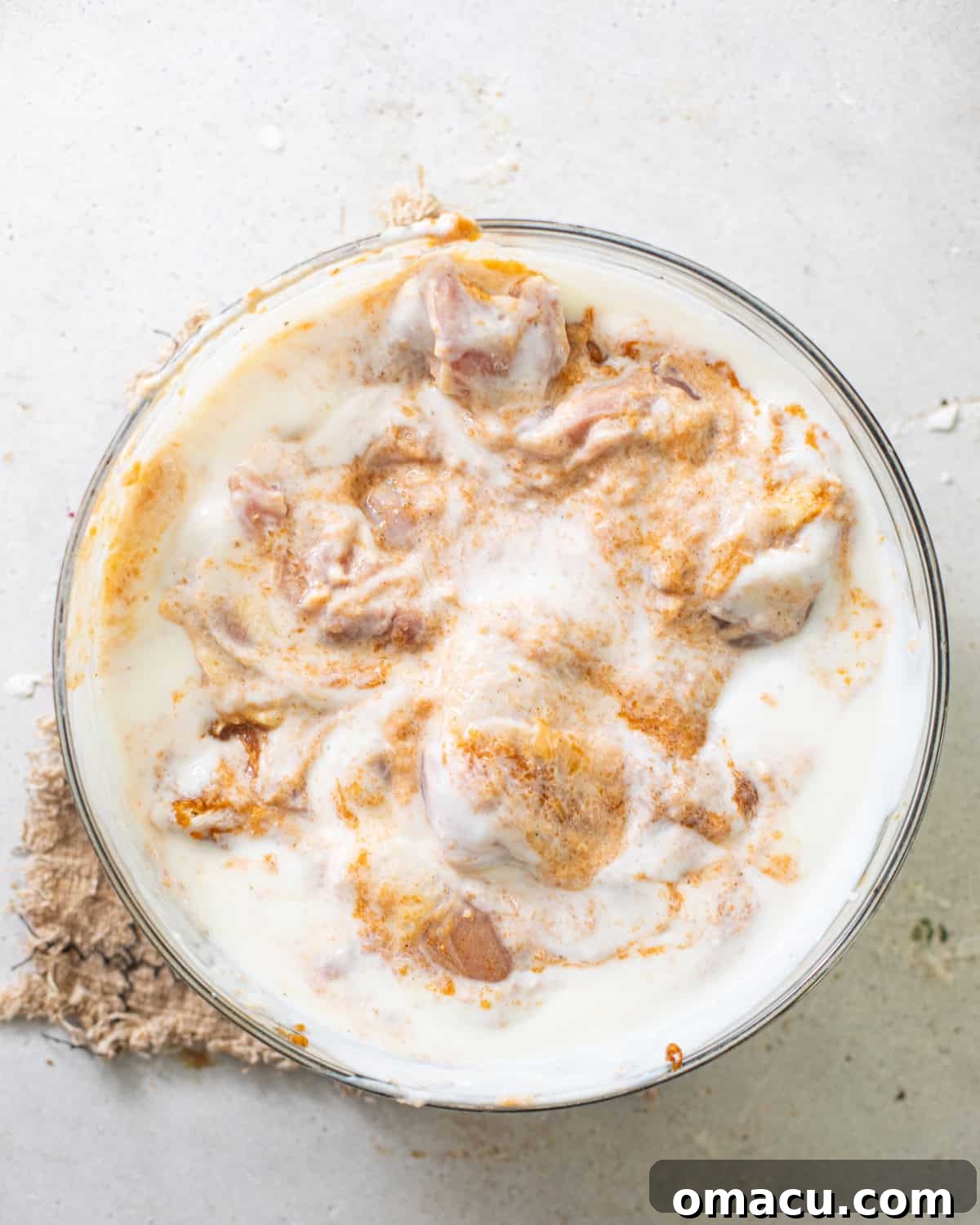 chicken marinating in a buttermilk and pickle juice brine.