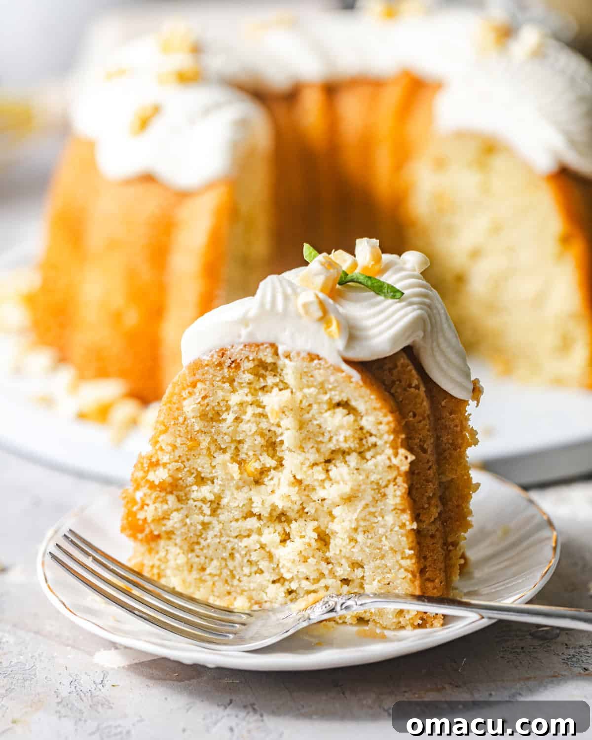 sliced corn pound cake on a plate with a fork. 