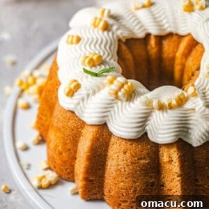overhead photo of corn pound cake on a cake plate with honey buttercream on top.
