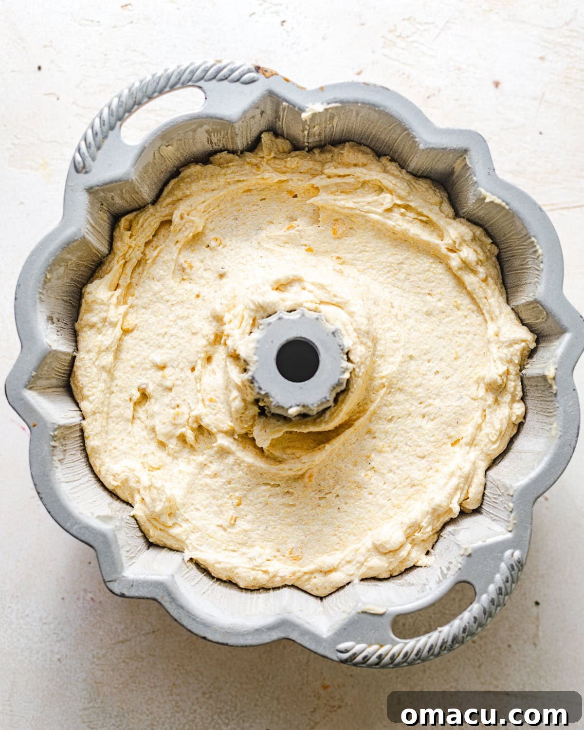 corn cake batter in a bundt pan. 
