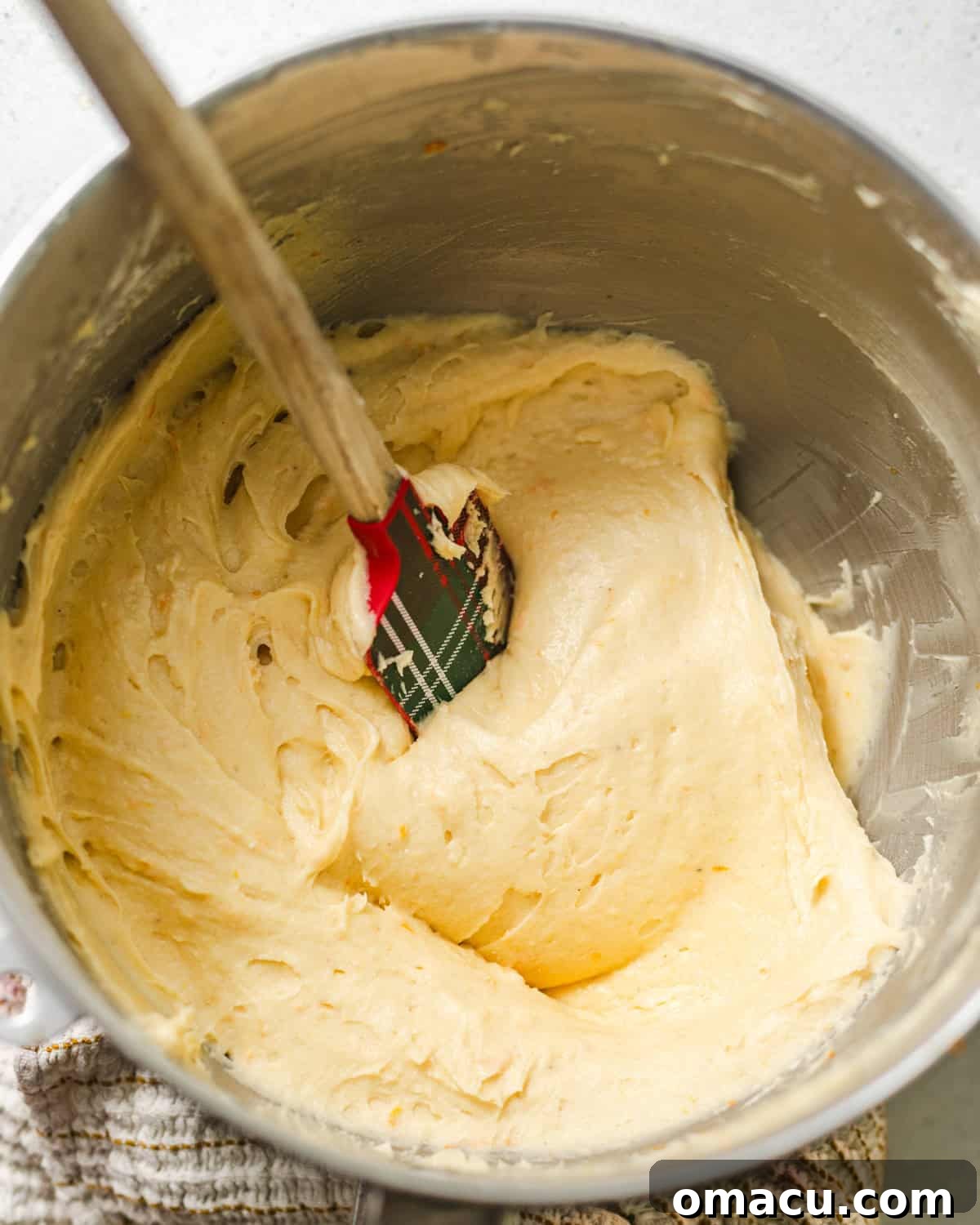Butter, sugar, vegetable oil, and orange zest creamed together in the bowl of a stand mixer, creating a light and fluffy base for the apricot cake batter.