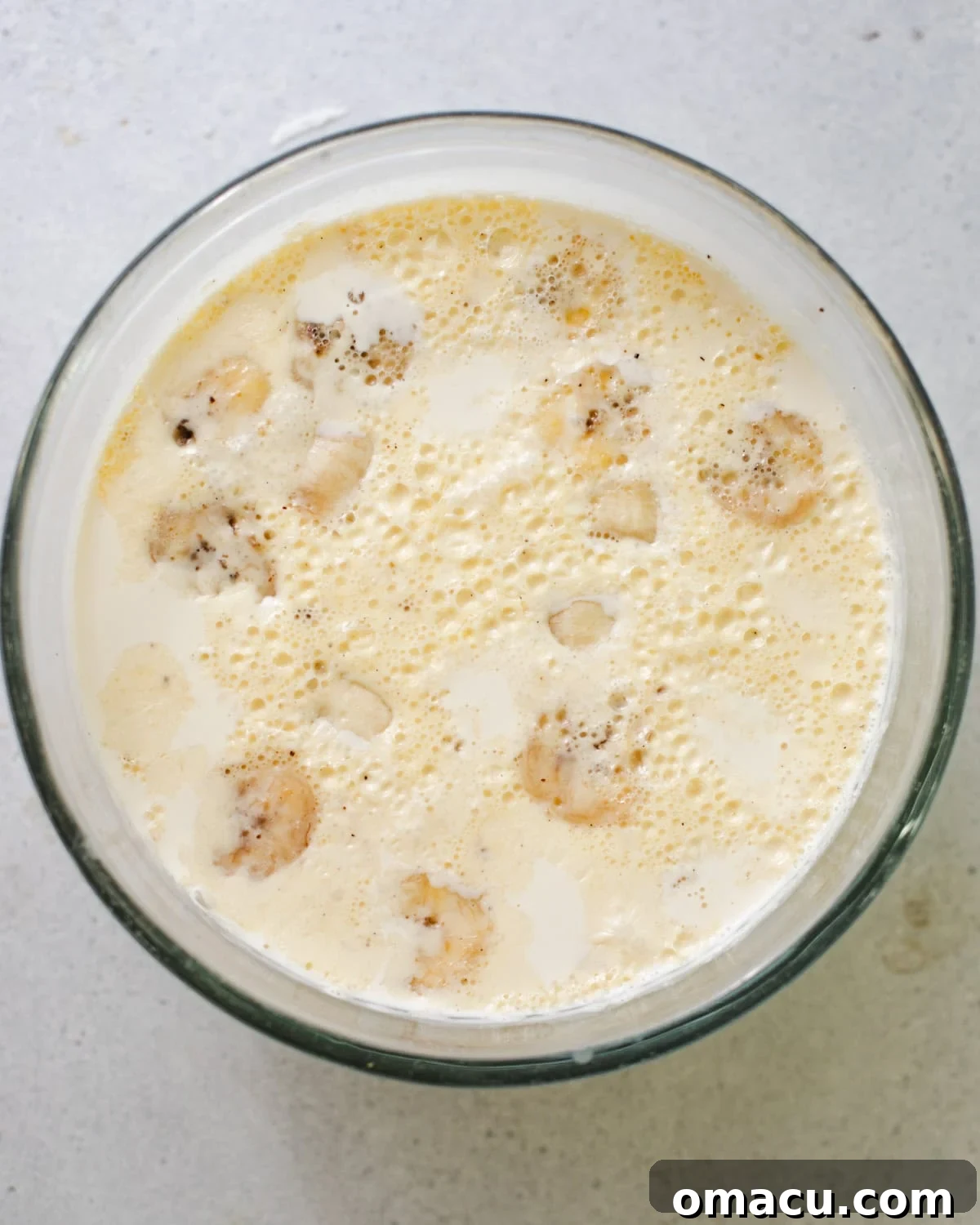 Slices of ripe bananas gently infusing in warm heavy cream, alongside vanilla bean paste, creating the base for the banana whipped cream.