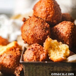 A beautiful stack of golden hush puppies, showcasing their crispy texture.