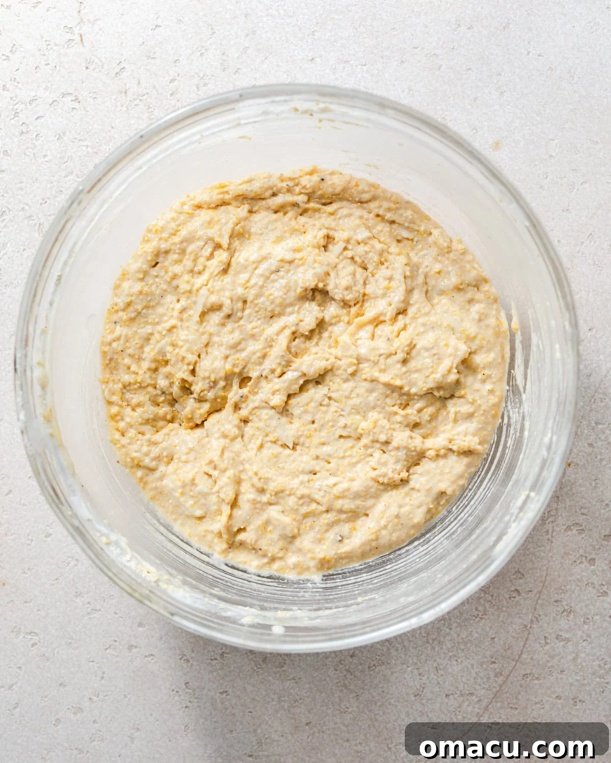 Hush puppy batter in a mixing bowl after wet and dry ingredients have been combined.