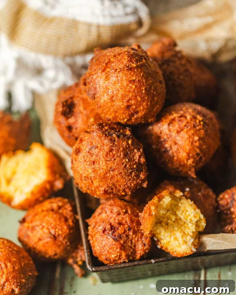 Overhead shot of freshly fried hush puppies served in a rustic basket.