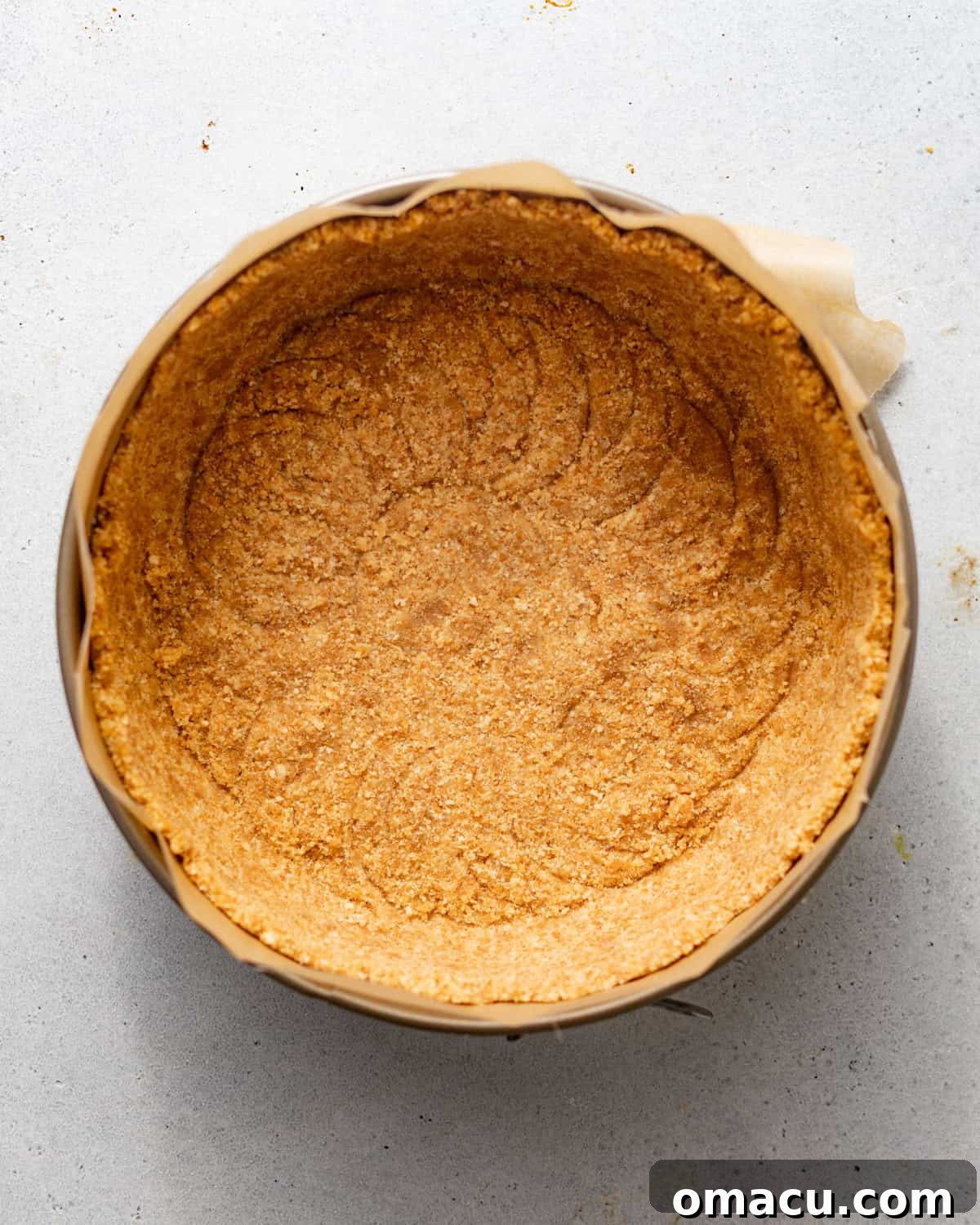 A buttery Nilla wafer crust firmly pressed into the bottom and up the sides of a springform pan.