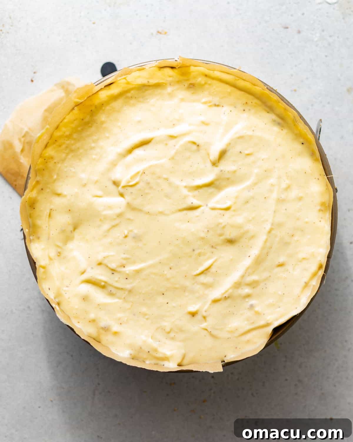 The banana pudding cheesecake fully assembled in a springform pan, ready for its water bath bake.