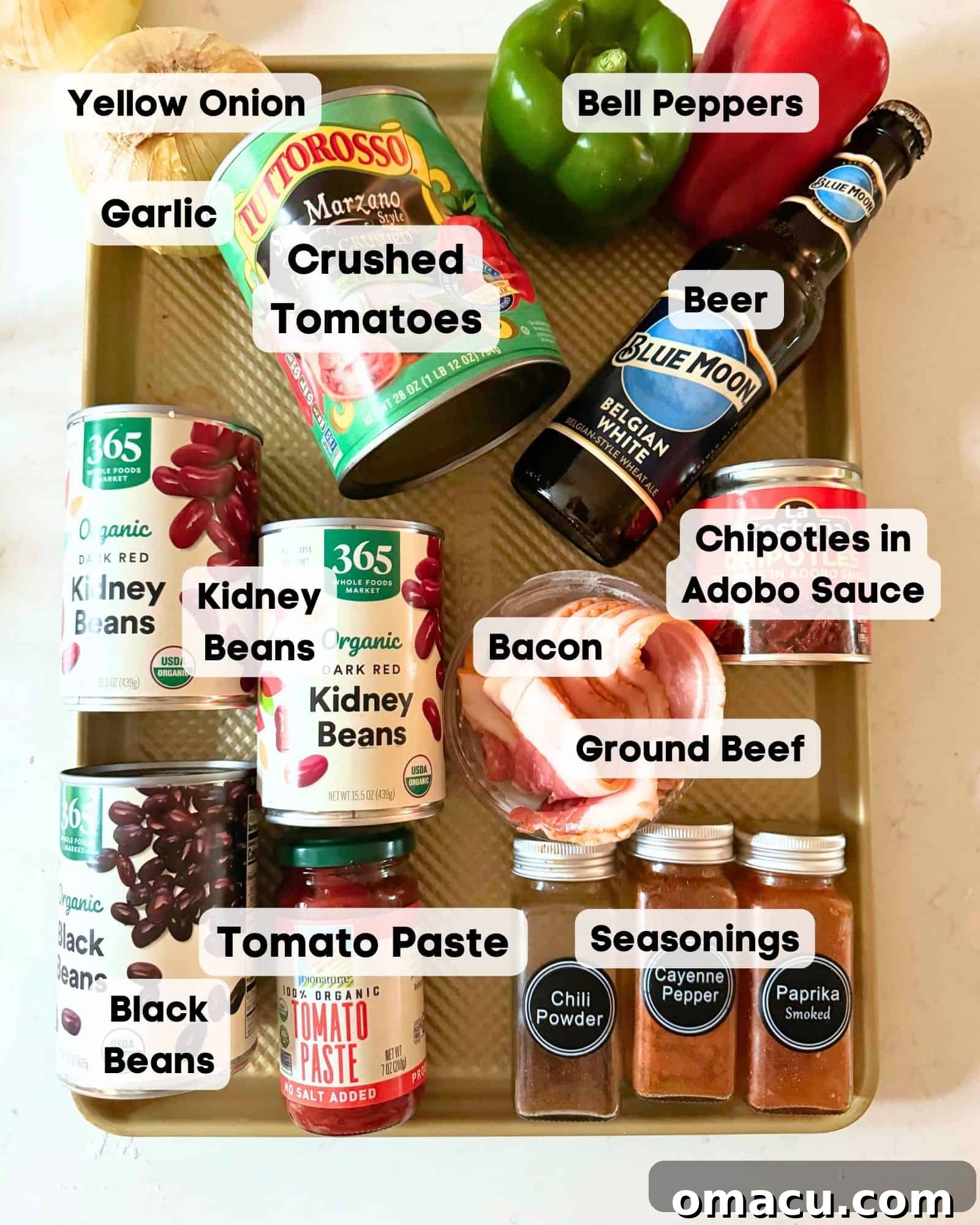 A collection of fresh ingredients laid out on a baking sheet, ready to be prepared for making homemade chili.