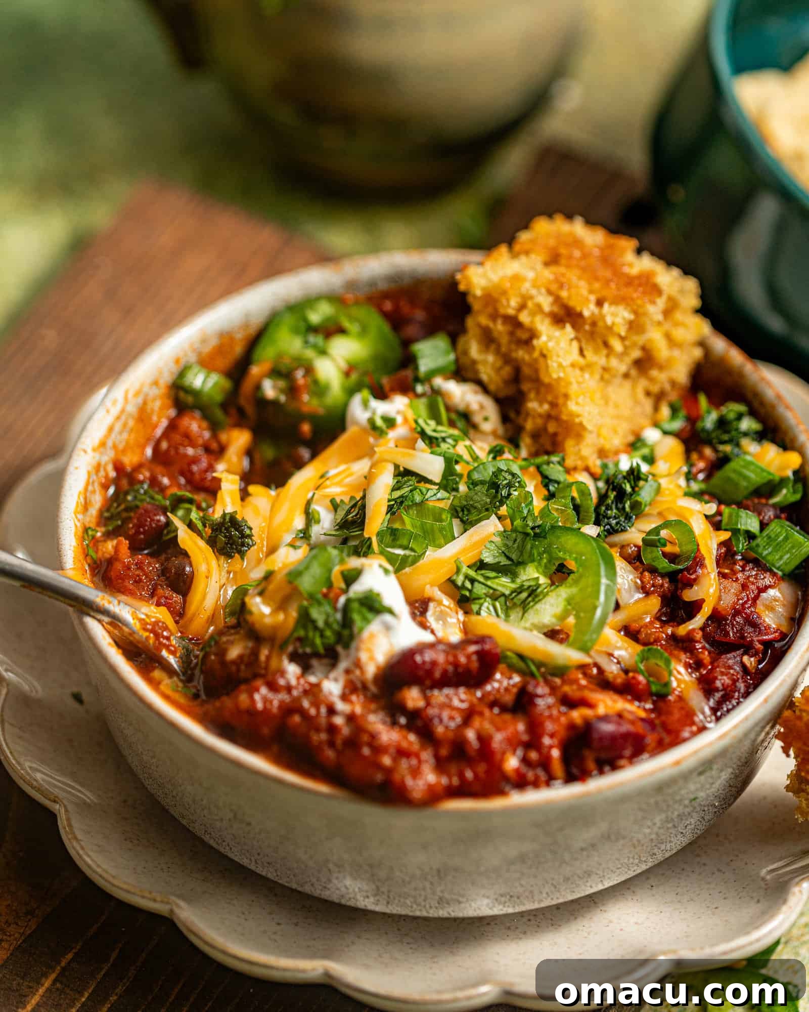 A Dutch oven full of rich, simmering chili, ready to be served, showcasing its deep color and hearty texture.