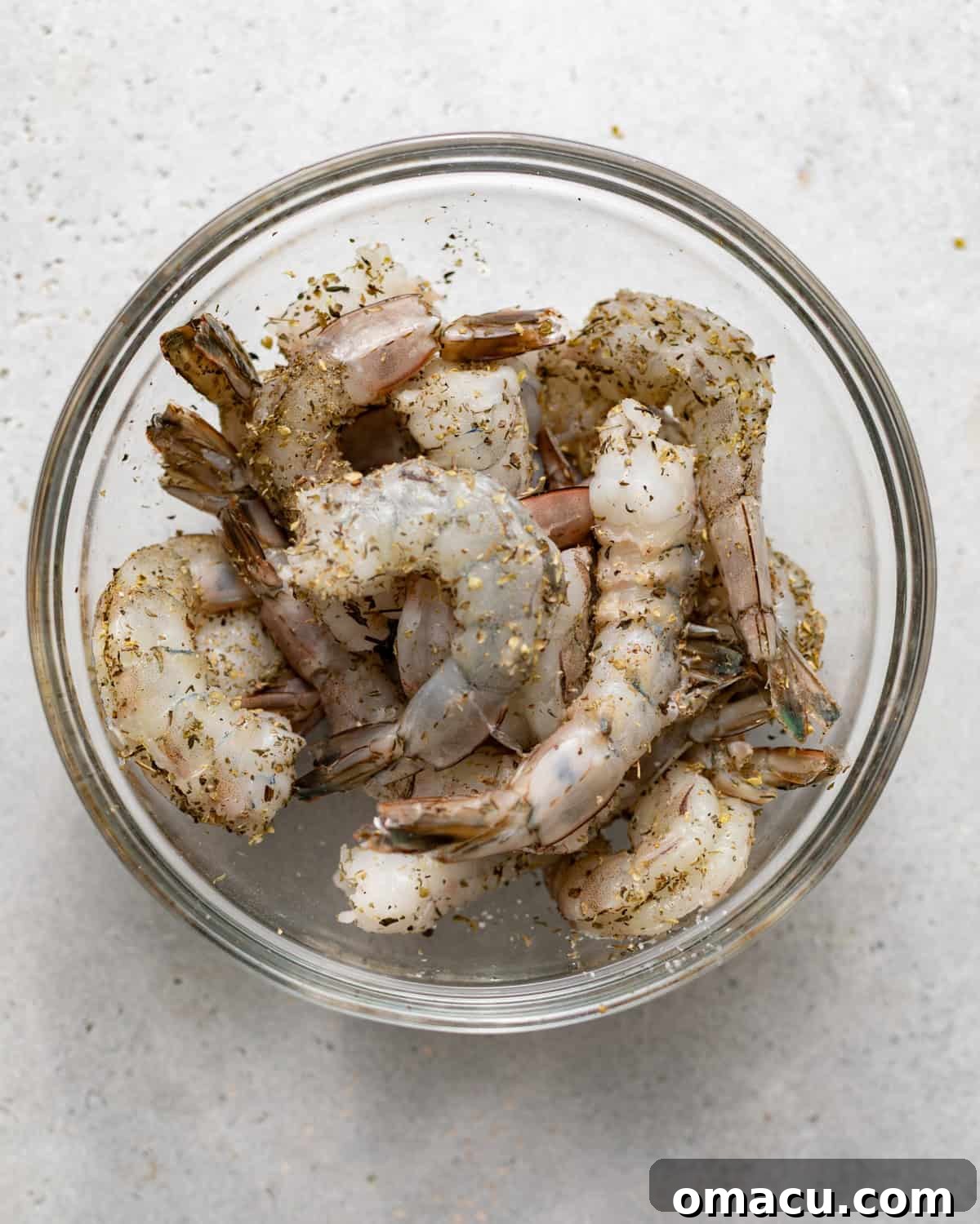 raw shrimp seasoned in a bowl. 