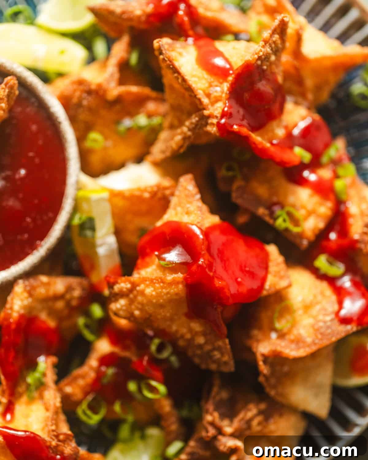 up close photo of crab rangoons on a plate.