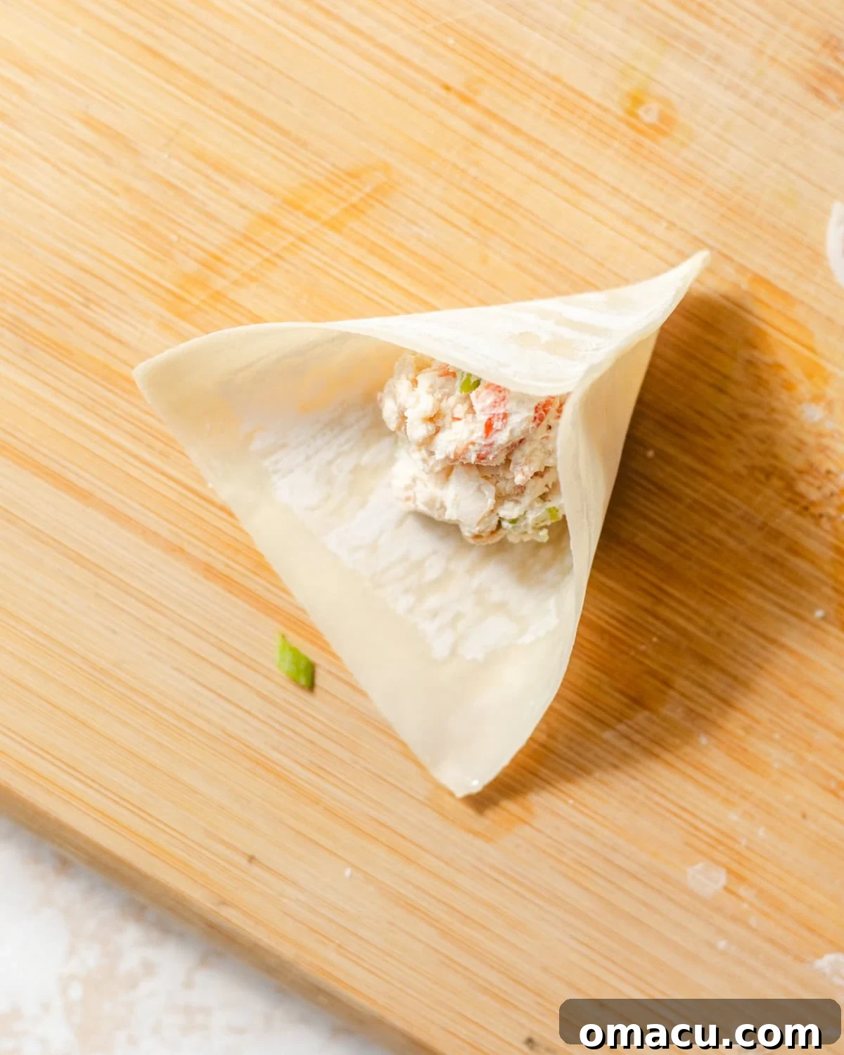 wonton wrapper with crab filling in the center.
