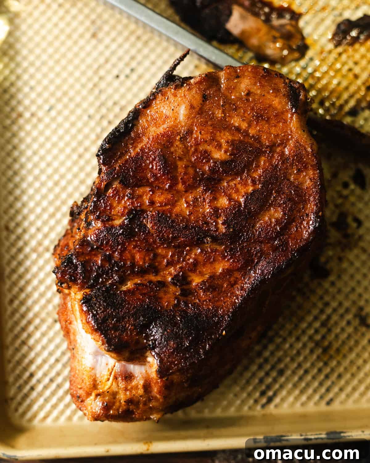 seared pork roast on a baking sheet.