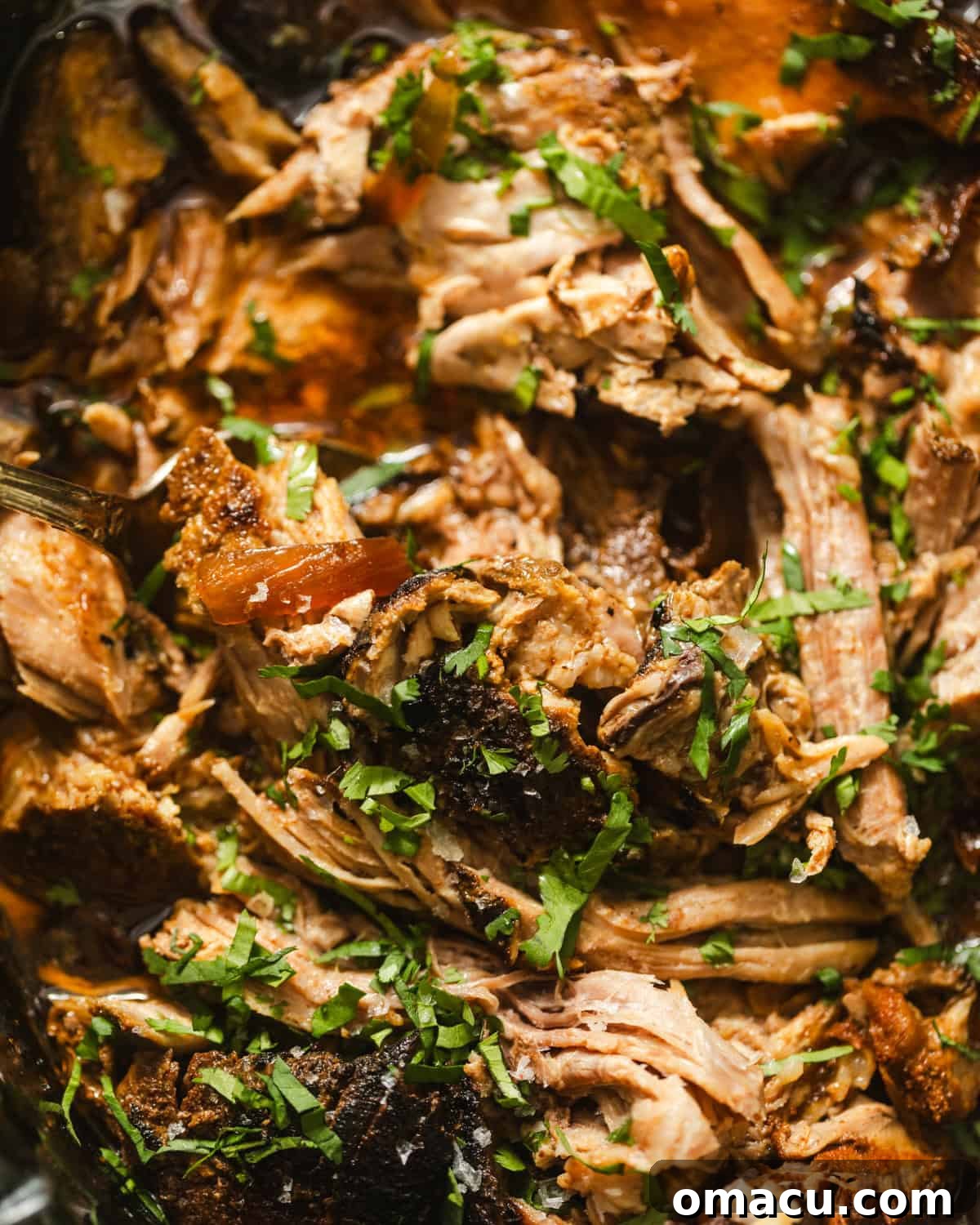 overhead photo of slow cooker pork roast shredded in a slow cooker.