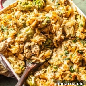 overhead photo of baked chicken and broccoli alfredo in a baking dish with a spoon.