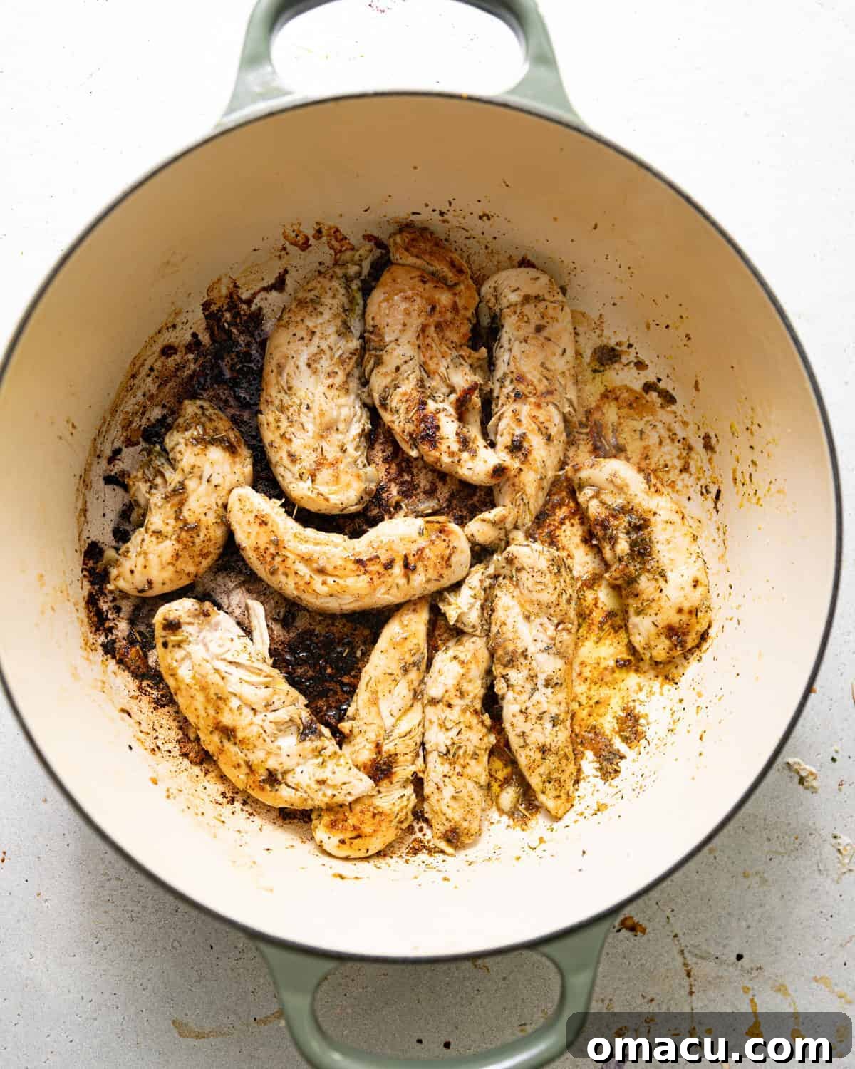 seared chicken in a large pot. 