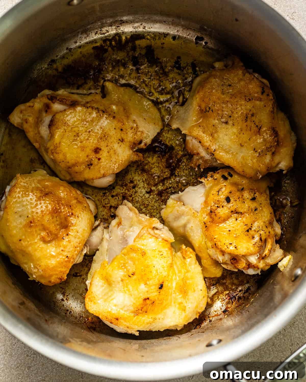 seared chicken in pot. 
