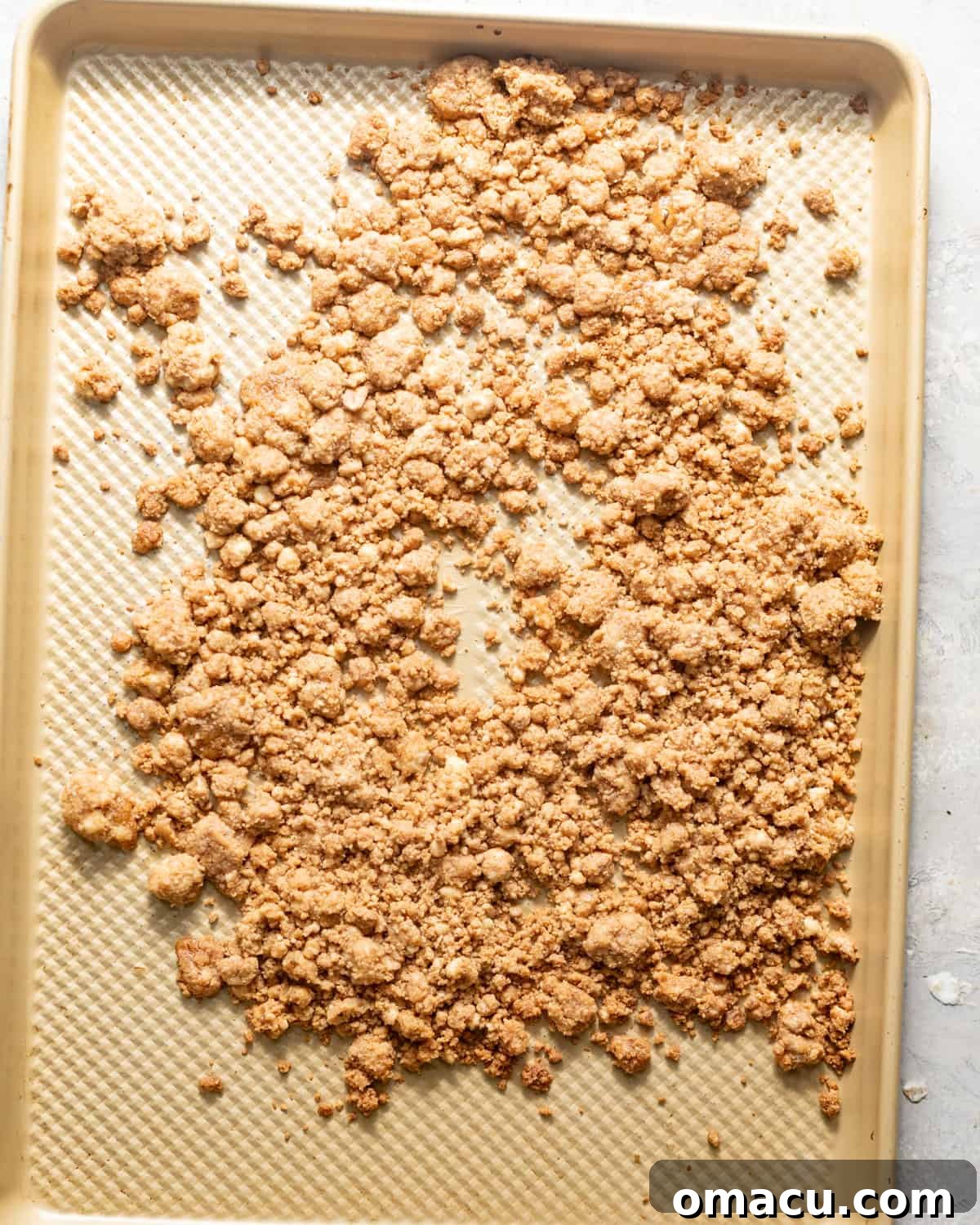 cinnamon crumbles on a baking sheet.