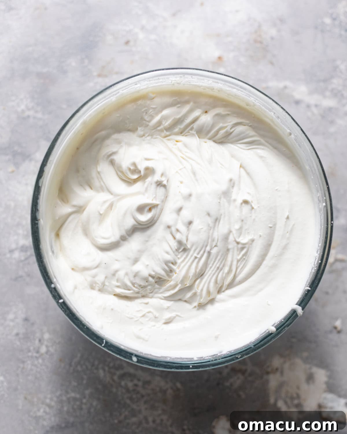 heavy cream and sweetened condensed milk whipped together until stiff peaks form in a bowl.