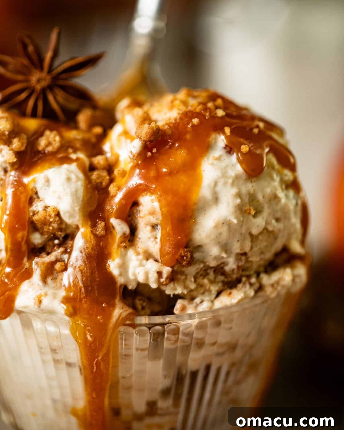 up close photo of apple pie ice cream in an ice cream cup.