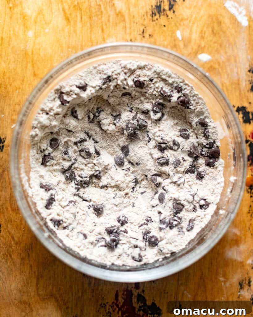 Dry ingredients mixed in a bowl with chocolate chips, tossed to coat.