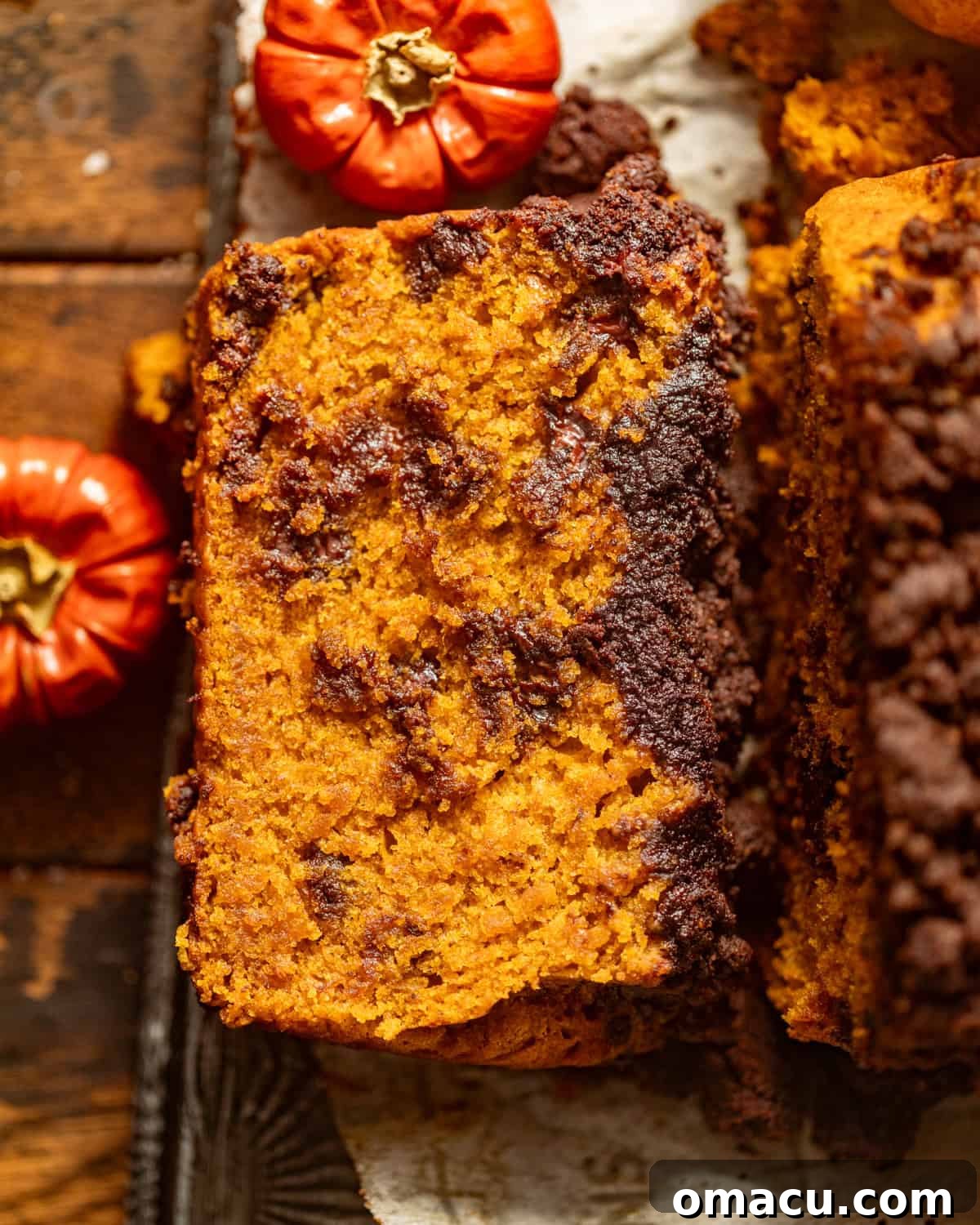 Slices of chocolate chip pumpkin bread artfully arranged on a serving tray.