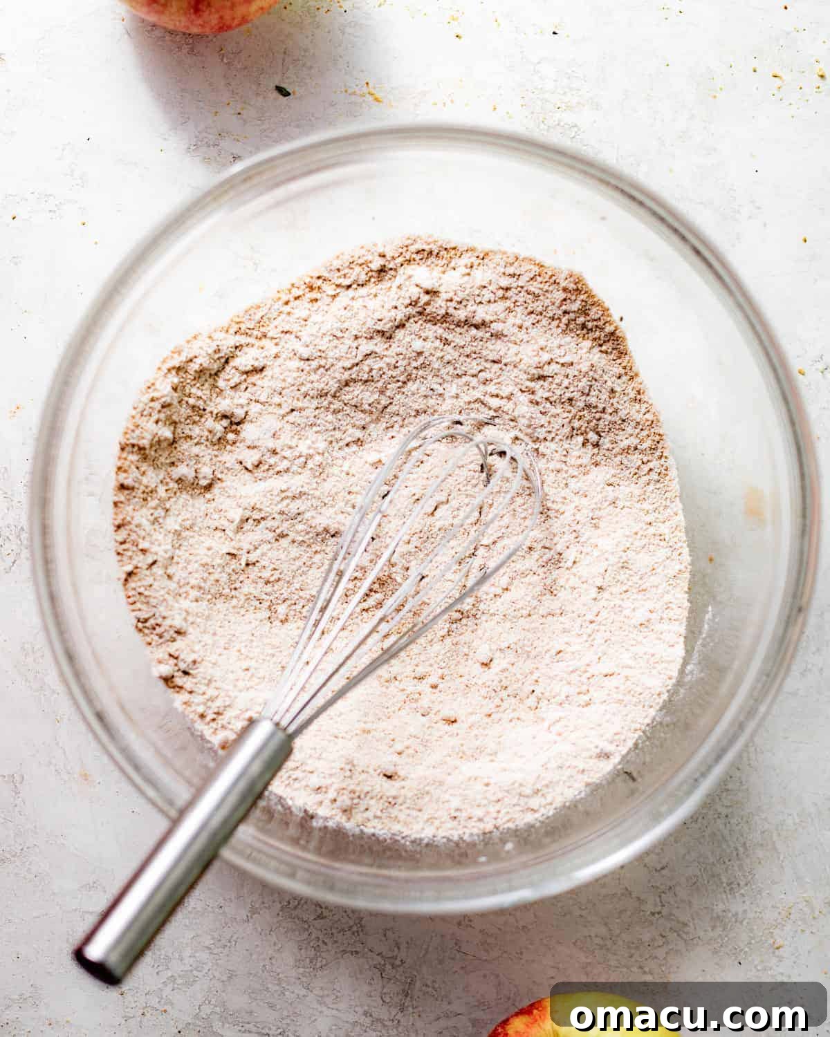 Dry ingredients, including flour and spices, perfectly whisked together in a large mixing bowl, ready for the wet ingredients.