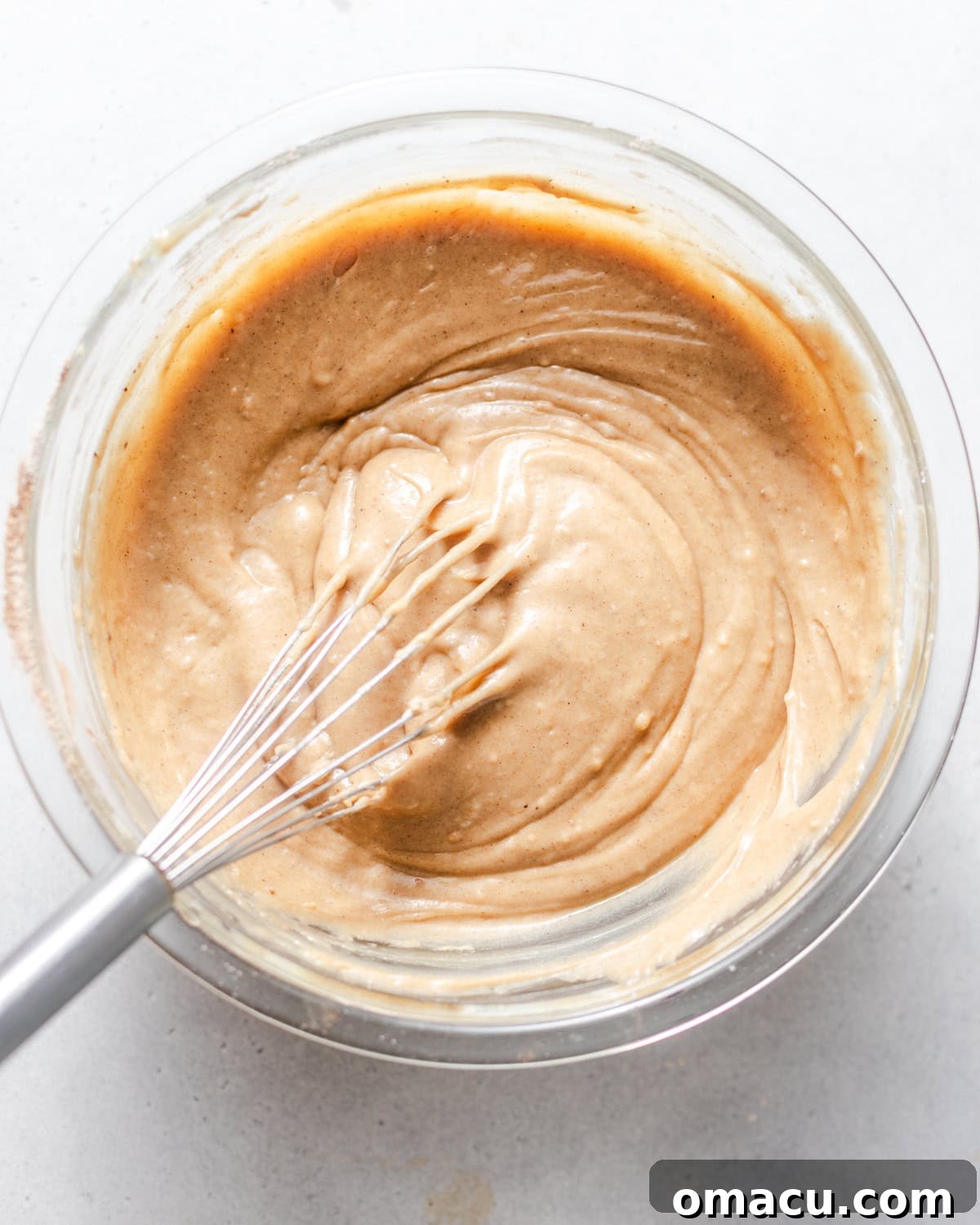 Smooth and well-mixed apple coffee cake batter in a large mixing bowl.